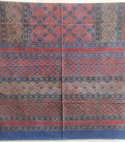 rich maroon cotton ajrakh bedsheet styled on bed traditional design