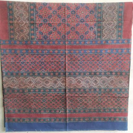 rich maroon cotton ajrakh bedsheet styled on bed traditional design