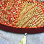 orange now add and create a title with a power word and the title in the short description and with images and videos   current title is multicolor and deep orange Barmer Round Table Runner - Cotton Embroidered Patchwork (flower and leaf design)    now follow all the instructions and guideline of the rankmath    Category is stole and link is and shop now word with link of category https://ajrakhaura.com/product-category/table-runner/     now strictly keep product description in long section length to 3000 words with the reference image     These are instructions and Guideline from the rankmath for seo Basic SEO : 1. Add Focus Keyword to the SEO title. 2. Add Focus Keyword to your SEO Meta Description. 3. Use Focus Keyword in the URL. 4. Use Focus Keyword at the beginning of your content. 5. Use Focus Keyword in the content. 6. Content should be 600-2500 words long.(this content is for product description (long))     Additional SEO : 1. Use Focus Keyword in subheading(s) like H2, H3, H4, etc.. 2. Add an image with your Focus Keyword as alt text. 3. Keyword Density is 0. Aim for around 1% Keyword Density. 4. URL is 25 characters long. Kudos! 5. Link out to external resources. 6. Add DoFollow links pointing to external resources. 7. Add internal links in your content. 8. Set a Focus Keyword for this content. 9. Use Content Al to optimise the Product.         Title Readability : 1. Use the Focus Keyword near the beginning of SEO title. 2. Your title has a positive or a negative sentiment. 3. Your title doesn't contain a power word. Add at least one. 4. Your SEO title doesn't contain a number.     Content Readability : 1. You don't seem to be using a Table of Contents plugin 2. You are using short paragraphs. 3. Your content contains images and/or video     keep the order of content: 1. title of product 2. create a url with the focus keyword 3. product decription (long) 4. Product short description 5. Rankmath meta description 6. focus keyword 7. ALT Tag for product images